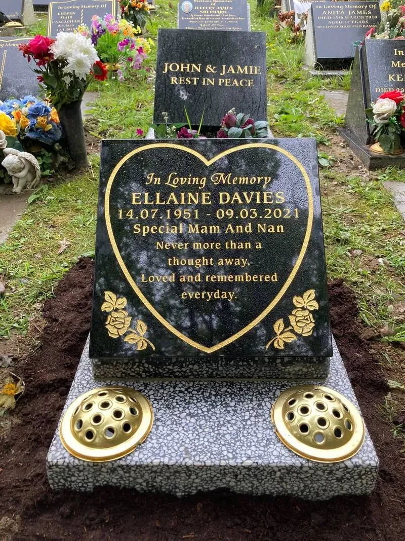 Black granite heart tablet with gilded roses and inscription, set on a polished kerb with brass vases by FR Terrazzo, Rhondda Cynon Taff