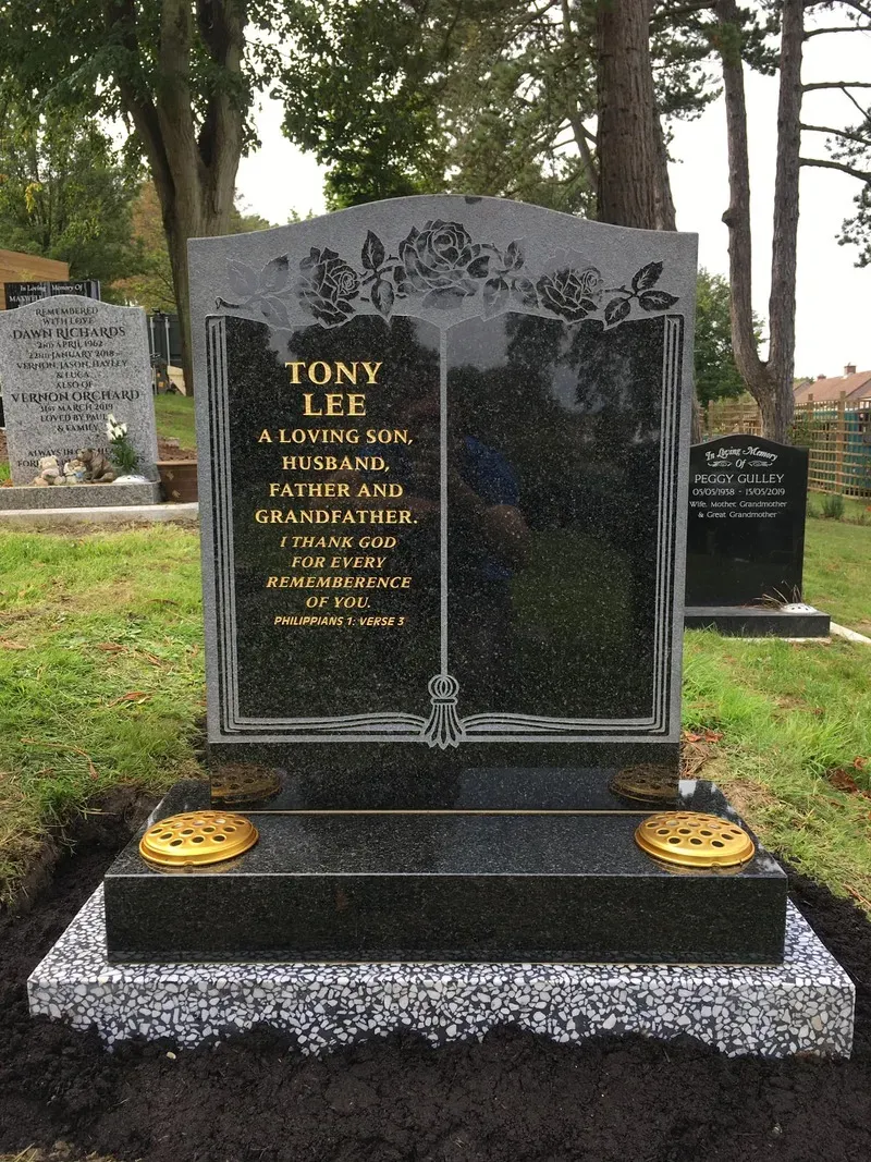 Open book memorial in black granite with etched roses and gold leaf lettering by FR Terrazzo, Rhondda Cynon Taff